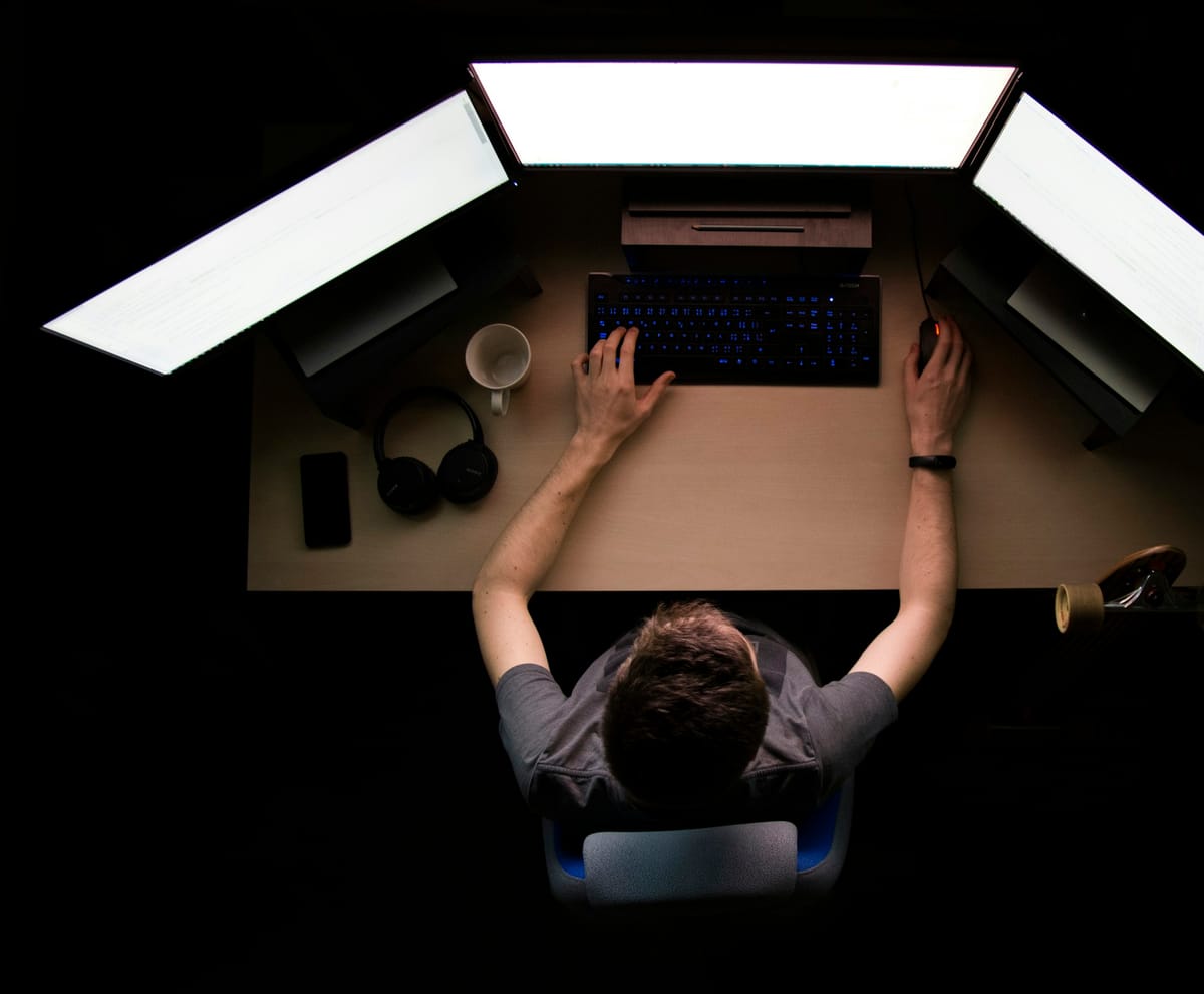 AventixIT engineer monitoring client systems from a dual-screen workstation